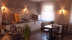 a kitchen and dining room with a table and chairs at Hotel Rosengarten Tuttlingen in Tuttlingen