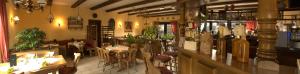 ein Restaurant mit Tischen und Stühlen und eine Bar in der Unterkunft Gasthof "to`n Eikbom" in Dargen