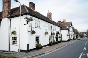 a row of white buildings on a street at The Crown Inn in Bishops Waltham
