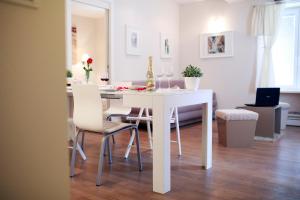 a white dining room table with chairs and wine glasses at Apartments Tkalča in Zagreb