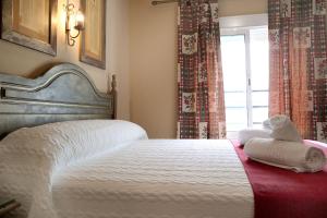 Postel nebo postele na pokoji v ubytování Hostal Victoria