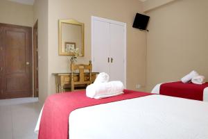 Postel nebo postele na pokoji v ubytování Hostal Victoria