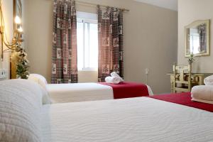 Postel nebo postele na pokoji v ubytování Hostal Victoria
