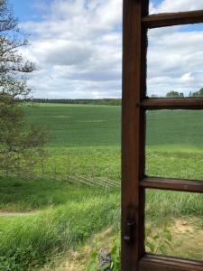 een uitzicht op een veld door een raam bij Stora Djulö Vandrarhem in Katrineholm