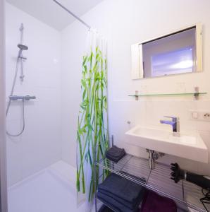 a bathroom with a sink and a shower at Domaine l'Ancien Vignoble in Saint-Julien-de-Lampon