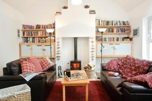 a living room with two couches and a fire place at Portsalon Luxury Camping in Portsalon