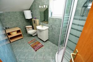 a small bathroom with a toilet and a sink at Apartment Blue in Sali