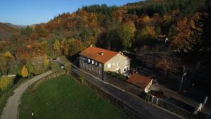 an aerial view of a house in the middle of a forest at la grange de loghju in Villefort