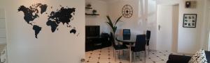 a living room with a table and a world map on the wall at Apartment Melany in Senj