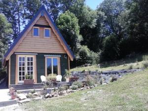 a small house with two chairs in front of it at Le Chalet de Chameil in Avèze