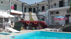 a swimming pool in front of a building at Star Apartment in Kallithea Halkidikis