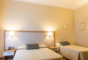 Letto o letti in una camera di Hotel Alpi Resort