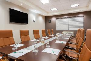 a conference room with a long table and chairs at Wyndham Garden Edmonton Airport in Leduc