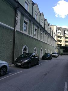 a row of cars parked in front of a building at Vila Park in Rogaška Slatina