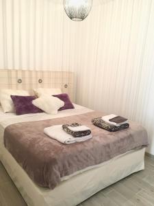a bedroom with two beds with towels on them at La Villa aux Oliviers in Le Val