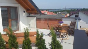 a patio with a table and chairs on a balcony at Willa Balticana in Władysławowo