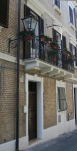 a brick building with a balcony and a door at B&B Dolce Casa in Vasto