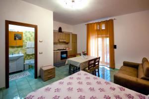 a kitchen and a living room with a bed and a table at Case Vacanze Rossi in Tramonti