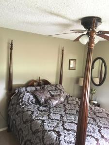 a bedroom with a bed and a ceiling fan at The Carriage House of Canton in Canton