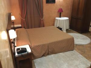Postel nebo postele na pokoji v ubytování Hotel Al Ritrovo