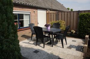 a black table and chairs on a patio at Vakantiehuis in Oosterwolde