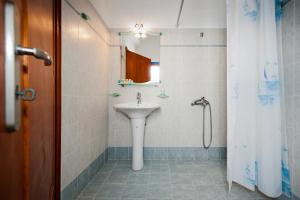 a bathroom with a sink and a shower at Hotel Eleni in Adamantas