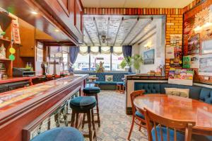 a restaurant with a bar and tables and chairs at The Strathdon in Blackpool