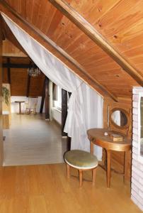 a room with a table and a chair and a wooden ceiling at Idyllic place near Cerknica Lake in Cerknica