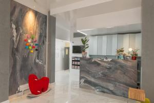 a red heart chair in a room with a wall at Victoria Inn London in London