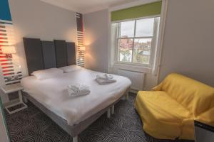 
Ένα ή περισσότερα κρεβάτια σε δωμάτιο στο Victoria Inn London

