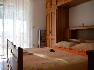 a bedroom with a large bed and a large window at Apartman Luna in Dugi Rat