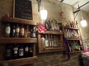 a bar with bottles of alcohol on the wall at Le Viole B&B in Mergo