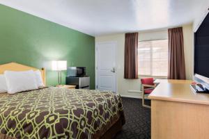 a hotel room with a bed and a desk at Downtown Inn in Eugene