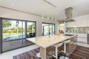 a kitchen with a large table and a pool at Family Country House in Faro