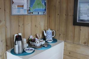 a shelf with a coffee pot and a tea kettle at Town & Beach Motel in Falmouth