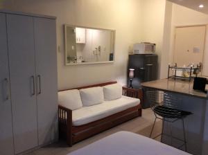 a room with a couch with a counter and a kitchen at Ipanema Prudente 205 in Rio de Janeiro