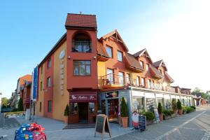 a building on the side of a street at Puchacz - Spa in Niechorze