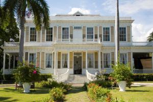 a large white house with a porch at Winchester Sunshine in Kingston