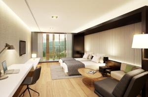 Pokój hotelowy z łóżkiem i biurkiem w obiekcie The Qube Resort Jeju w mieście Seogwipo
