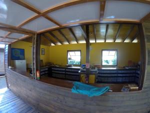 an inside view of a large room with a large wooden building at Painapaopao Backpacker in Moorea