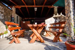 a wooden table and two chairs on a patio at Family guesthouse in forest Ana & Stjepan Nikolić in Međugorje