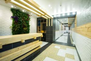 a hallway with a plant on the wall at Zolotoe Vremya Hotel in Khabarovsk