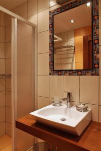 a bathroom with a sink and a mirror at Xenonas Afroditi in Loutra