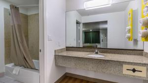 a bathroom with a sink and a mirror at Motel 6-San Marcos, TX - North in San Marcos +20 photos