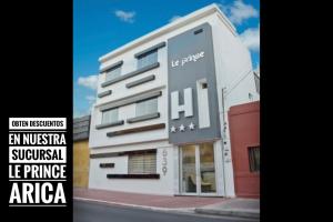 a white building with a sign on the side of it at Le Prince Tacna in Tacna