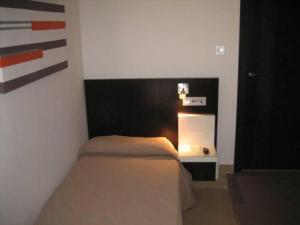 Posteľ alebo postele v izbe v ubytovaní Hostal Central