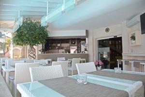 a restaurant with tables and chairs and a bar at Foglie D' Acqua in Bisceglie
