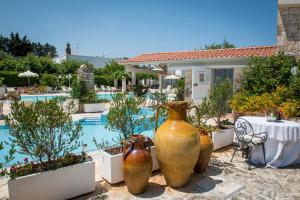 a group of large vases sitting next to a pool at Agriturismo Salinola in Ostuni