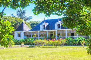 a white house with a blue roof at Auberge de Saint Aubin in LʼUnion
