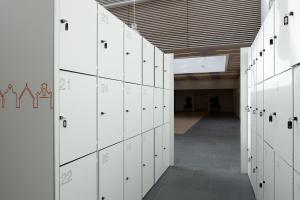 a hallway with white lockers in a building at easyHotel Amsterdam Zaandam in Zaandam